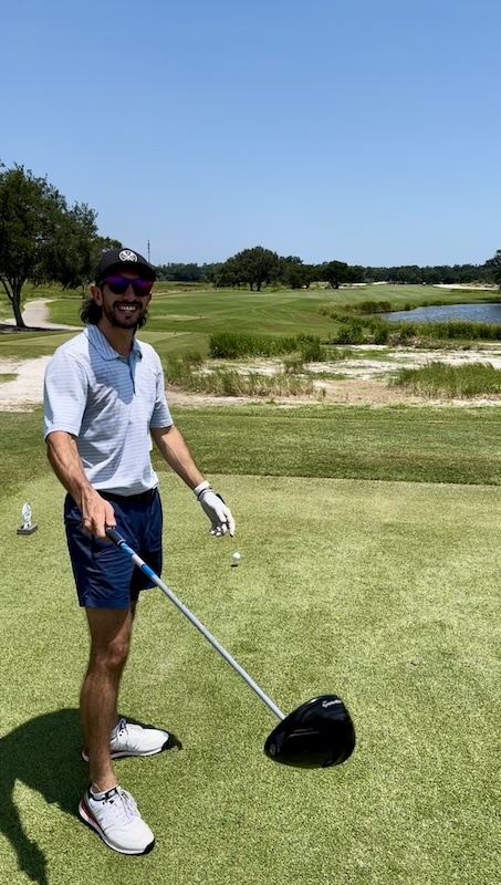 Phen playing golf in the sun.